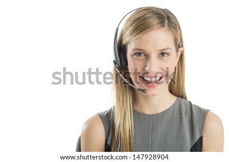 Close-up portrait young female customer service representative wearing headset smiling against white background