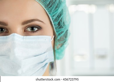 Close-up Portrait Of Young Female Surgeon Doctor Or Intern Wearing Protective Mask And Hat. Healthcare, Medical Education, Emergency Medical Service, Surgery Or Veterinary Concept