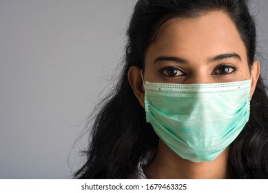 Closeup Portrait Of A Young Girl Or Woman Doctor Wearing A Medical Or Surgical Mask