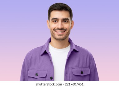 Close-up Portrait Of Young Handsome Smiling Man Wearing Purple Shirt And White T-shirt, Isolated On Purple Background