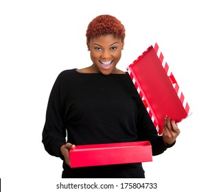 Closeup portrait of young happy excited woman opening red gift box, very pleased and grateful with what she received, isolated on white background. Positive emotion facial expression feeling attitude