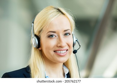 Closeup Portrait Young Happy Successful Business Woman, Customer Service Representative, Call Centre Worker, Operator, Support Staff Speaking With Head Set Isolated Background Corporate Office Windows