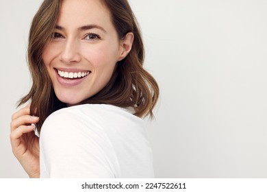 closeup portrait of young happy woman looking in camera	