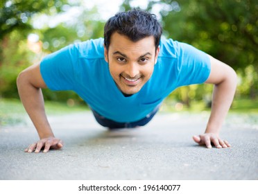 Closeup Portrait, Young Healthy Handsome Man Performing Pushup Outside On Road In Park, Isolated Trees And Sky Background. 