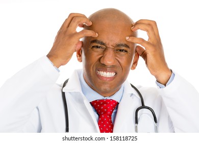 Closeup Portrait Of A Young Male Doctor, Having Bad News, Headache, Stressed Out, Going Through A Lot Of Stress Isolated On White Background. Health Care Reform, Medicaid Plan Reimbursement. Obamacare