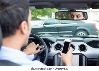 Closeup Portrait, Young Man In Blue Polo Shirt Driving In Black Car And Checking His Phone, Then Shocked Almost About To Have Traffic Accident, Isolated Interior Car Windshield Background
