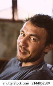 Close-up Portrait Of A Young Man. The Man Laughs. A Sly Smile.