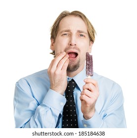 Closeup Portrait, Young Man With Sensitive Tooth Ache Problem Pain From Cold Frozen Purple Ice Cream, Hand On Mouth, Isolated White Background. Negative Human Emotion, Facial Expressions, Feelings