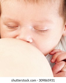 Close-up portrait. Young mother breastfeeds her baby. Breast-feeding.