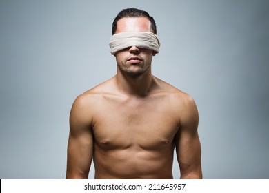 Close-up Portrait Of Young Naked Blindfold Man.