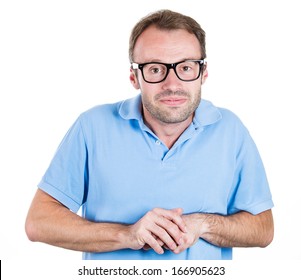 Closeup portrait of a young nerdy looking man with glasses, very timid, shy and anxious, playing with hands nervously, isolated on a white background. Mental health, emotion facial expression feeling - Shutterstock ID 166905623