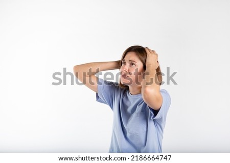 Close-up portrait of young panicking woman isolated on white background