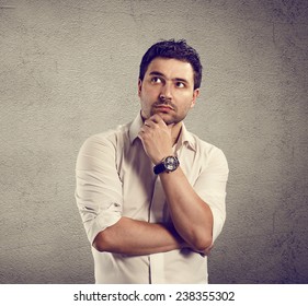 Close-up Portrait Of Young Pensive Businessman Standing At The Wall. Male Thinking Of Right Decision. 