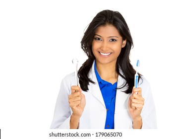 Closeup portrait of young pretty, beautiful, confident, smiling, cheerful female oral health care professional, dentist, showing toothbrush and tongue scraper, isolated on white background.