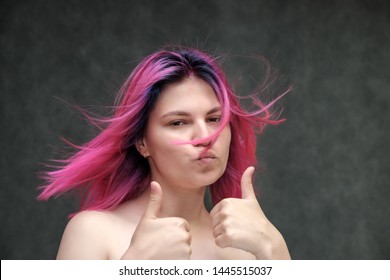 Close-up Portrait Of A Young Pretty Teen Girl With Beautiful Purple Hair On A Gray Background In The Studio. Smiles With Emotions