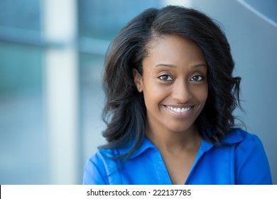 Closeup Portrait, Young Professional, Beautiful Confident Woman In Blue Shirt, Friendly Personality, Smiling Isolated Indoors Office Background. Positive Human Emotions