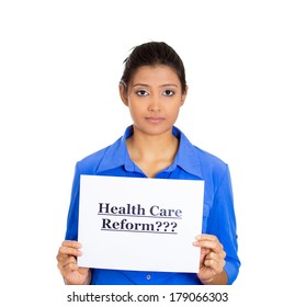 Closeup Portrait Of A Young Serious Woman Holding A Sign Health Care Reform, Uncertain Of Universal Insurance Coverage, Isolated On A White Background. Politics, Government , Legislation