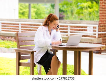 Closeup Portrait, Young Smiling Confident Female Doctor, Healthcare Professional Talking On Phone, Giving Consultation Isolated Background Hospital Park. Patient Visit Health Care. Positive Emotions