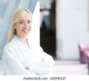 Closeup Portrait Young, Smiling, Confident, Female Doctor, Healthcare Professional With Stethoscope Standing, Looking At You Isolated Background Hospital Hallway. Patient Visit Care. Positive Emotion