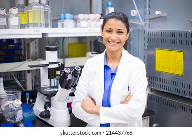 Closeup Portrait, Young Smiling Scientist In White Lab Coat Standing By Microscope. Isolated Lab Background. Research And Development.