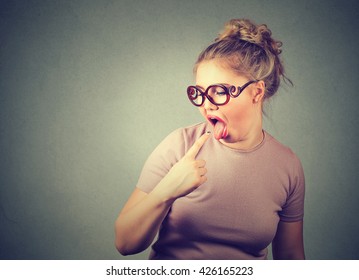 Closeup Portrait Young Woman, Annoyed, Frustrated Fed Up Sticking Her Finger In Her Throat Mouth Showing She Is About To Throw Up Isolated Gray Wall Background. Negative Human Face Expression Emotion 