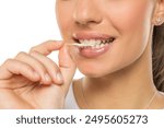 Closeup portrait of a young woman with chewing gum in her teeth