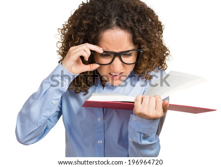 Closeup portrait young woman with eye glasses trying read book, having difficulties seeing text, because bad vision, sight problems, isolated white. Facial expression reaction health, eyesight issues