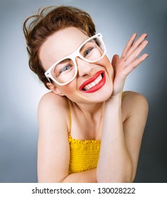 Close-up portrait of young woman in funny glasses with annoyed grimace