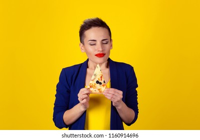 Closeup Portrait Young Woman Holding, Fatty Pizza Eyes Closed Of Pleasure, Enjoying The Smell And Craving Junk Food Not Trying To Resist Temptation Isolated Yellow Background. Positive Face Expression