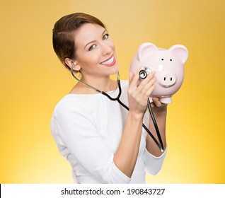 Closeup Portrait Young Woman Listening To Piggy Bank With Stethoscope. Medical Insurance, Medicare Reimbursement. Curious Nurse, Doctor, Patient Or Business Lady. Health Law Coverage, Company Report