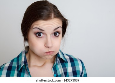 Closeup Portrait Of Young Woman With Mouth Full Of Air