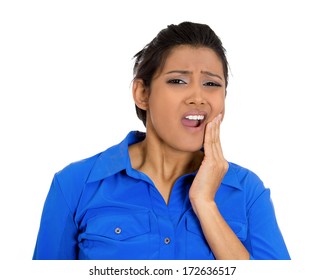 Closeup Portrait Of Young Woman With Sensitive Tooth Ache Crown Problem About To Cry From Pain Touching Outside Mouth With Hand, Isolated White Background. Negative Emotion Facial Expression Feeling