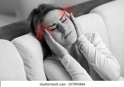 Closeup Portrait Of Young Woman Suffering From Head Ache. Head Highlighted With Red Color.