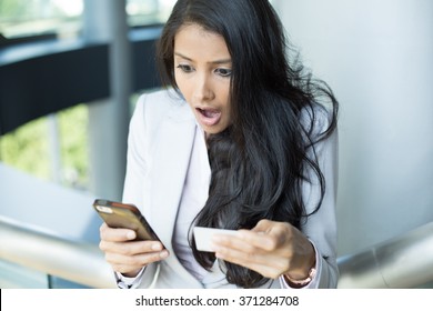 Closeup Portrait, Young Woman In White Gray Suit Looking At Cell Phone And Paper, Shocked At What She Sees, Isolated Indoors Background. Winning Lottery Ticket