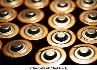A closeup of the positive ends of battery cells. 