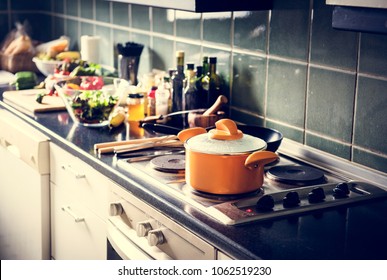 Closeup of pot on stove in the kitchen with cooking food - Shutterstock ID 1062519230