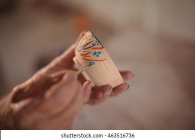 Close-up of potter painting on bowl in pottery workshop - Powered by Shutterstock