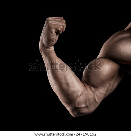 Close-up of a power fitness man's hand. Strong and handsome young bodybuilder demonstrate his muscles and biceps