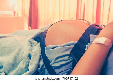 Closeup Of Pregnant Woman With Electrocardiograph Check Up For Her Baby In The Hospital. Fetal Heart ECG Monitoring. Diagnostic EKG. Healthcare Medical CTG Service.