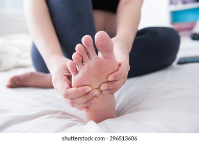 Closeup Of Pregnant Woman Hands Doing Foot Massage 