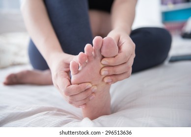 Closeup Of Pregnant Woman Hands Doing Foot Massage 