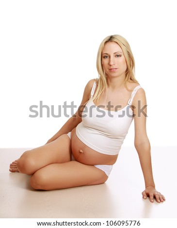 Closeup of a pregnant woman sitting on the floor