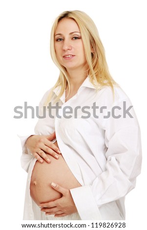 Closeup of a pregnant woman touching her belly with hands