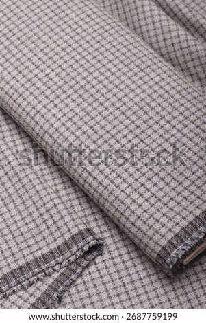 Close-up of premium, thick, patterned autumn-winter wool suiting fabric.