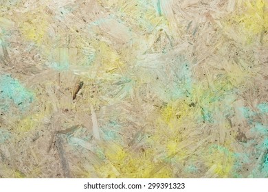 Close-up Of Pressboard Background With Green Yellow