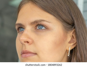 Close-up of pretty western woman face skin. Female eye. Texture of the dark brown eye is visible. Macro detail. Caucasian