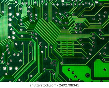 Close-up of a printed circuit board with chips, showing the complex connections and electronics parts. - Powered by Shutterstock