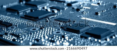 Closeup of Printed Circuit Board with  integrated circuits and many other passive electrical components.