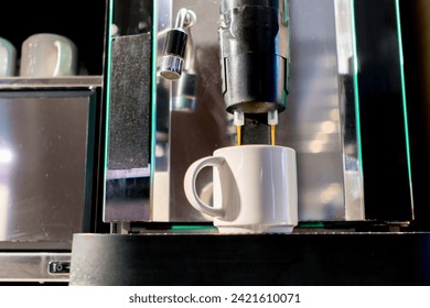 close-up of the process of making fragrant coffee with an automatic coffee machine in hotel