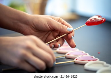 Close-up, the process of making heart-shaped lollipops, pouring marmalade into molds, handmade production. - Shutterstock ID 2148646823